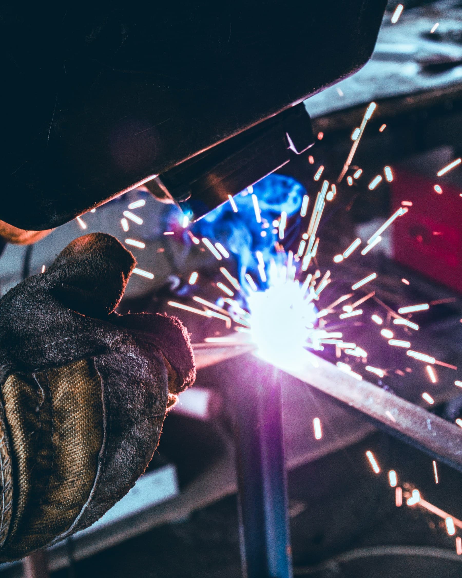 A real metalworker welding in an industrial workshop